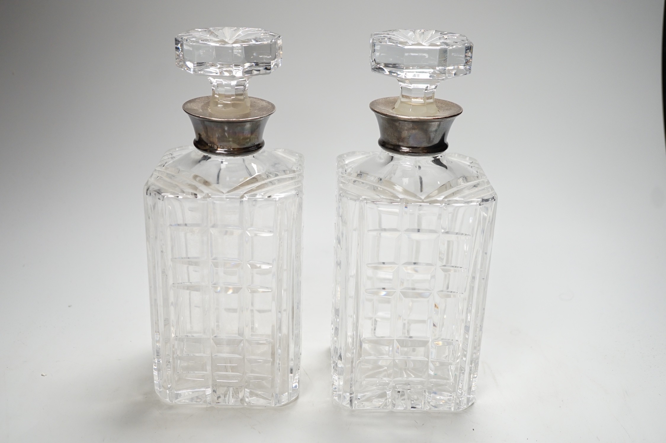 A pair of 20th century silver collared glass decanters and stoppers by Roberts & Dore Ltd, 24cm